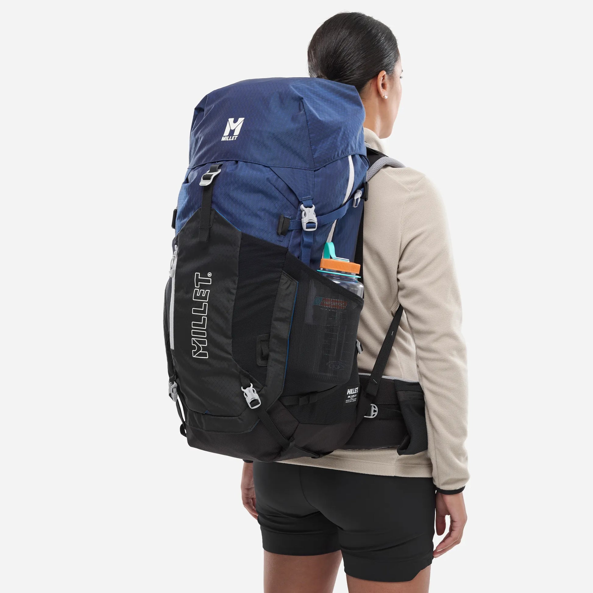 mochila Millet Ubic 50+10 mujer con botella colocada en el bolsillo lateral